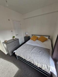 Bright double bedroom with modern grey furnitur...