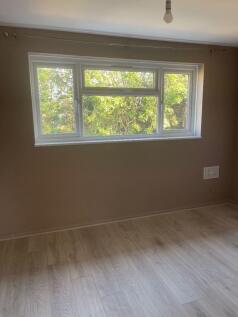 Bright bedroom with large window and modern flo...