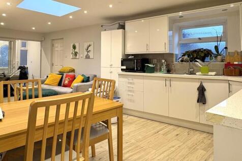 Bright open-plan living space with a modern fit...