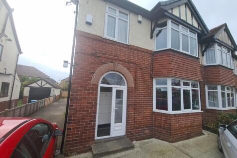 A charming front view of a traditional brick pr...