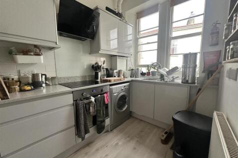 Bright kitchen with modern gloss units...