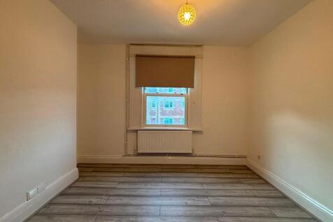 Bright and tidy room with modern wood flooring...