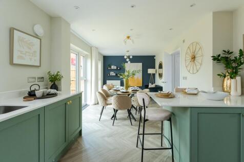 The kitchen flows seamlessly into the living spaces