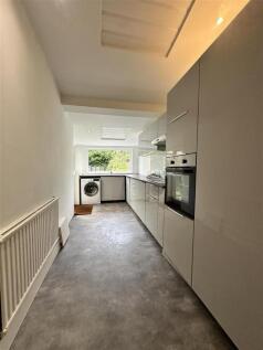 Modern galley kitchen with sleek white cabinets...