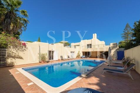 Moorish-style luxury villa for sale in Carvoeiro Clube, Algarve, featuring a large renovated swimming pool, sun terrace, and private garden.