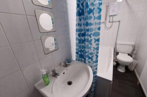 A clean and functional bathroom featuring a whi...