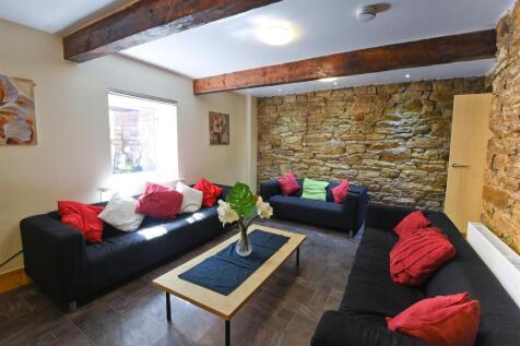 Charming living area with rustic stone wall...