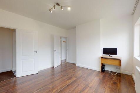 Bright and spacious room with stylish wood floo...