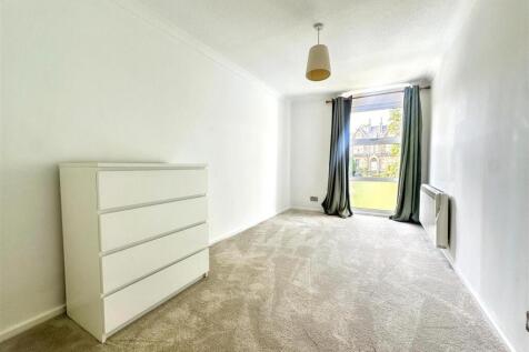 Bright and airy bedroom with modern storage...