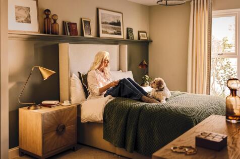 a person sitting on a bed with a dog