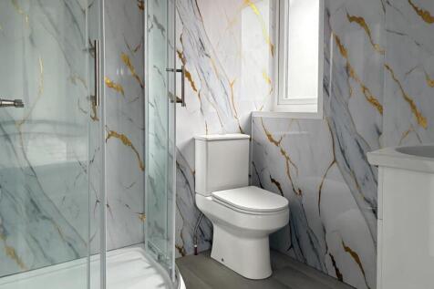 Modern bathroom with marble-effect tiled walls,...