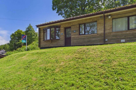 Exterior View Of The Timber Clad Lodge Set On A Gr