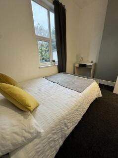 Bright and cozy single bedroom featuring a comf...