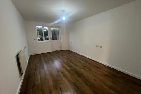 Bright long living room with wood flooring...