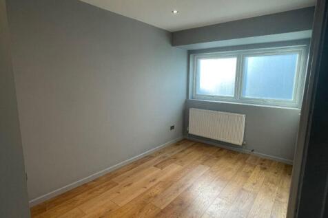 Bright bedroom with sleek wooden flooring...