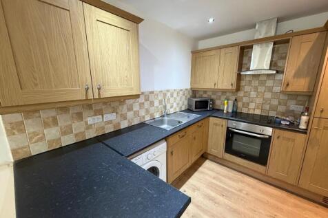 Well-appointed kitchen with wood-effect cabinet...