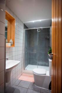 Modern tiled bathroom with glass shower...