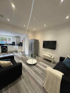 Modern and spacious living room featuring two c...