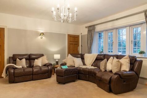 The main lounge on the front elevation with dual access doors to the entrance hall