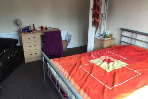 Spacious bedroom with a double bed and desk....