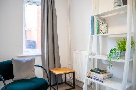 A bright and inviting living room with modern d...