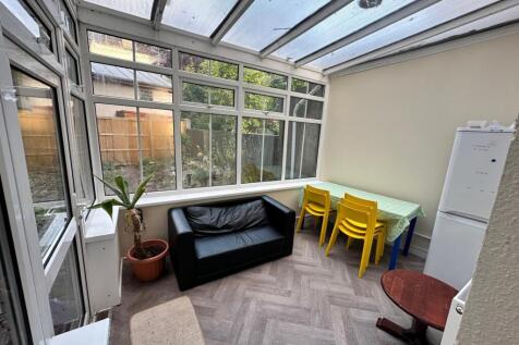 Bright conservatory-style communal lounge with ...