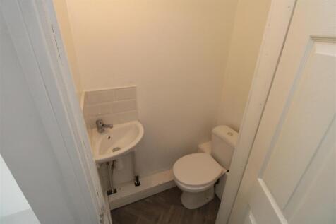 Bright and tidy modern cloakroom with wash basi...