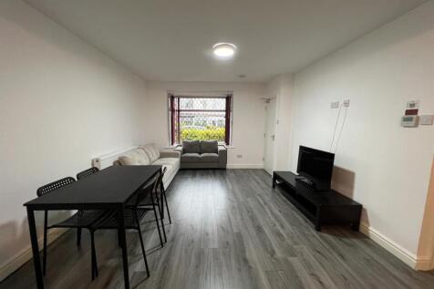 Bright, modern living room with sleek grey wood...