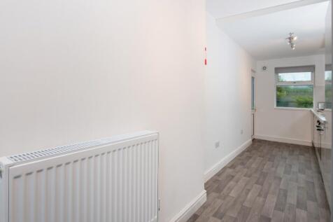 Bright, modern galley-style kitchen with fresh ...