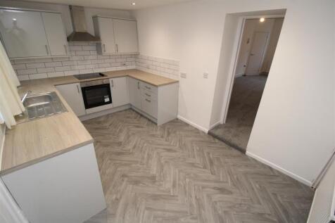 Modern kitchen with stylish herringbone floorin...