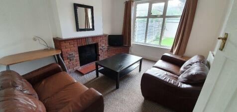 Cosy lounge with comfy leather sofas and window...