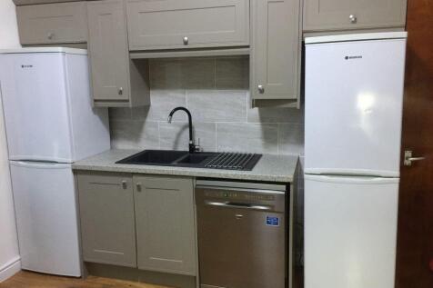 Modern compact kitchen with neutral cabinetry, ...