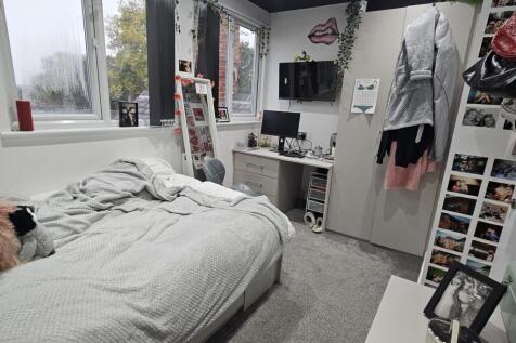 A cozy bedroom featuring a double bed, a large ...