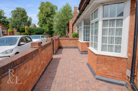 Brick house and garden path scene.png