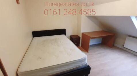 Neat furnished bedroom with a double bed, bedsi...