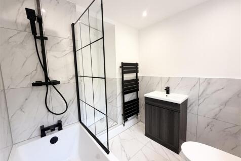 Modern marble-effect bathroom with sleek fixtur...