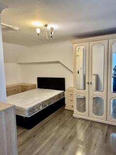 Bright bedroom with ample storage and sleek flo...