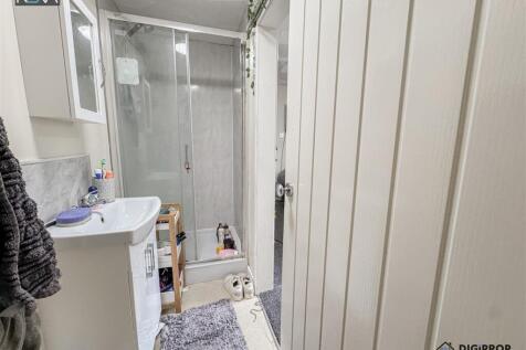 Bright bathroom with a modern glass shower...