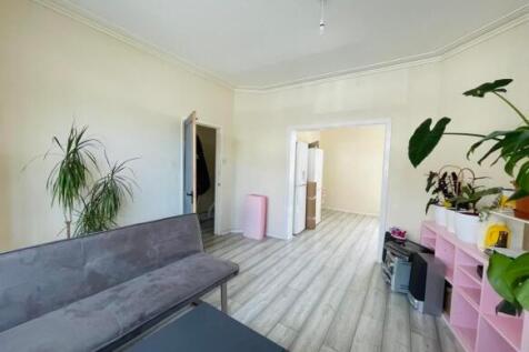 Bright, modern living room with light wood-effe...