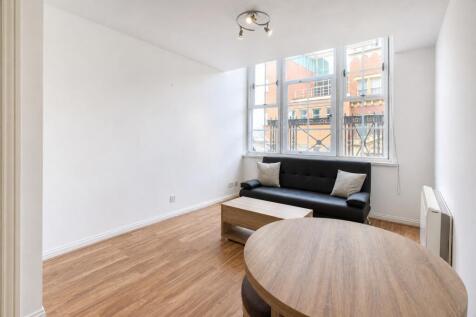 Bright lounge with a large window and sofa...