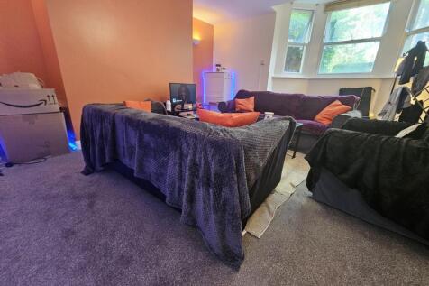 A cozy living room featuring a comfortable seat...