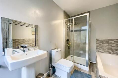 Modern bathroom suite with bath and shower....
