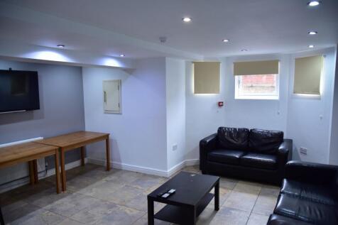 A well-lit, modern living room featuring a comf...