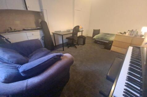 Spacious shared living room with multiple seati...