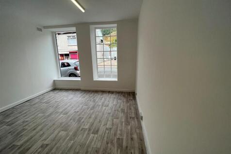 Bright living area with stylish wood flooring...