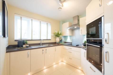 a kitchen with white cabinets