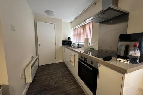 Modern galley kitchen with appliances and count...