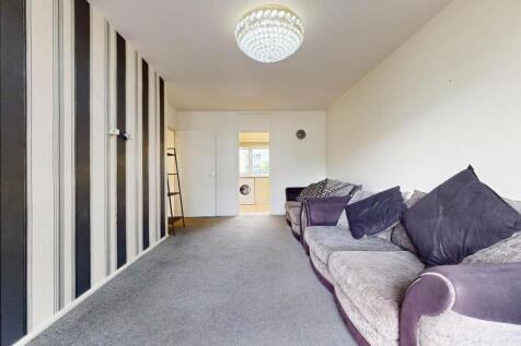 Bright living area with plush sofas...