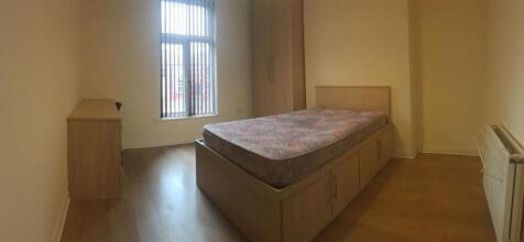 Bright, simply furnished bedroom with a raised ...
