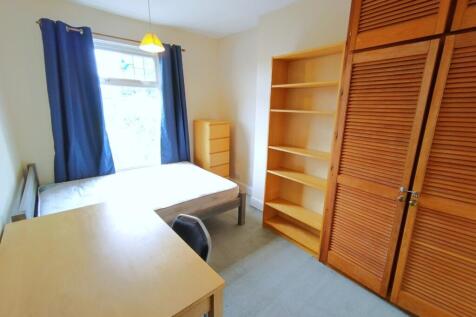 Bright bedroom with extensive storage space for...